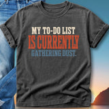 Dark t-shirt with red and orange text "MY TO-DO LIST IS CURRENTLY GATHERING DUST."