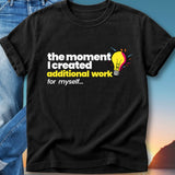 Black t-shirt with text "the moment I created additional work for myself..." and a lightbulb.