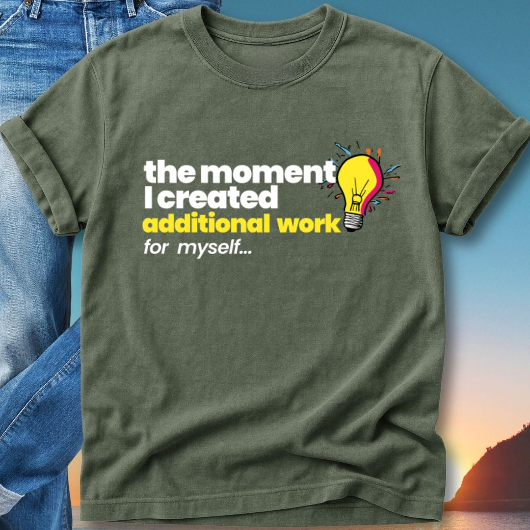 Green t-shirt with text "the moment I created additional work for myself" and a lightbulb graphic.