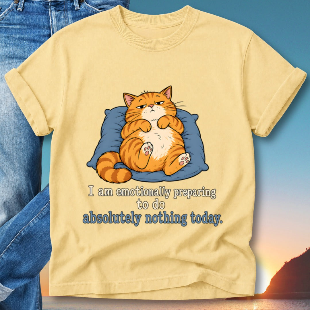Yellow t-shirt with a grumpy cat lying on a pillow, text reads "I am emotionally preparing to do absolutely nothing today."