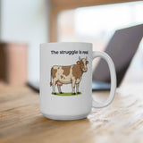 White mug with cartoon cow illustration and text "The struggle is real".