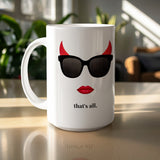 White mug with devil horns, sunglasses, red lips, and "that's all."