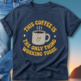 Dark blue t-shirt with "This coffee is the only thing working today" text and cartoon coffee mug.