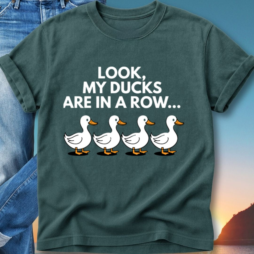 Dark green t-shirt with cartoon ducks and text "LOOK, MY DUCKS ARE IN A ROW..."