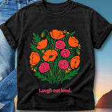Black t-shirt with vibrant orange poppy and pink rose floral design and "Laugh out loud." text.