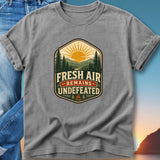 Gray t-shirt with "Fresh Air Remains Undefeated" mountain graphic.