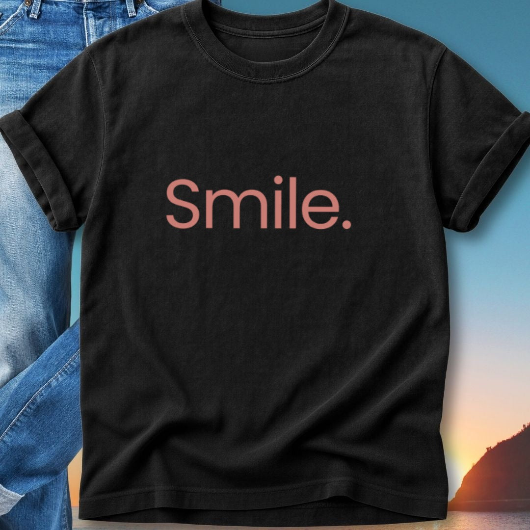 Black t-shirt with "Smile." in pink text, worn by a person.
