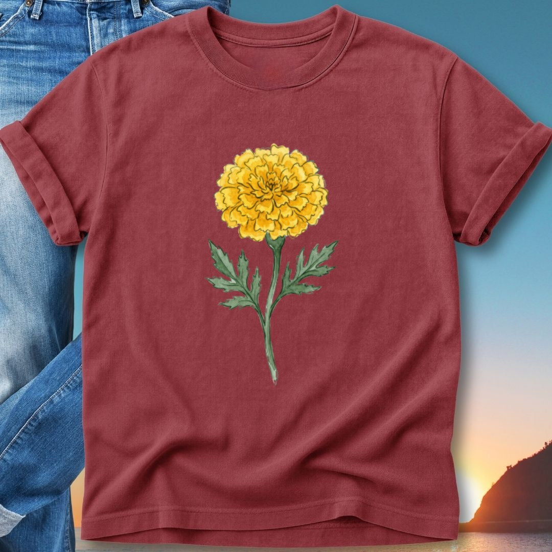 Maroon t-shirt featuring a watercolor illustration of a yellow marigold flower.