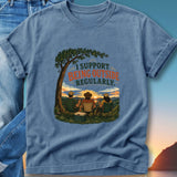 T-shirt graphic with text "I support being outside regularly" and three people watching a sunset.