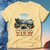 Yellow t-shirt with binoculars, chair, and scenic overlook sign.