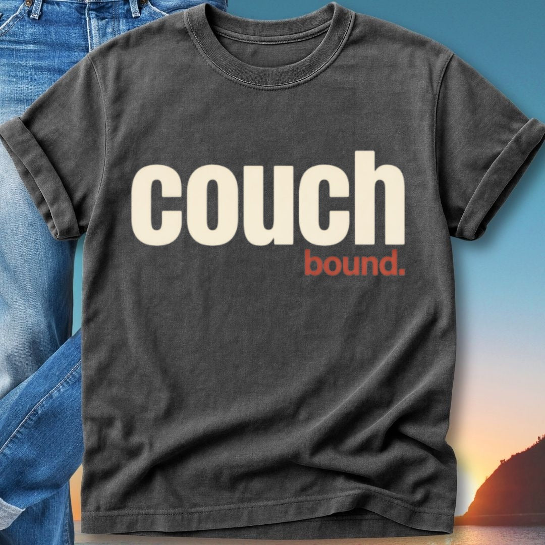 Dark t-shirt with "couch bound." text and jeans on a beach background.