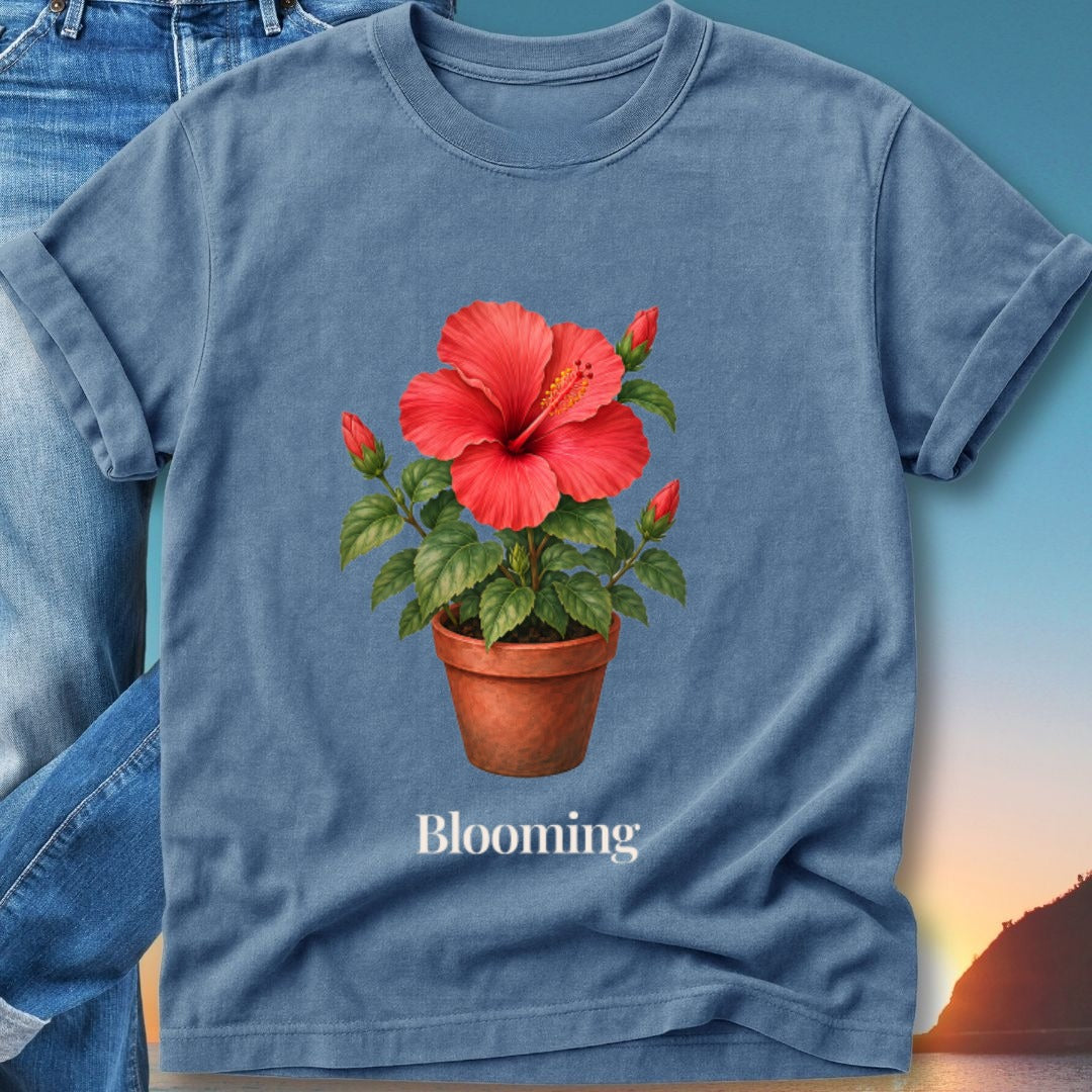 Blue t-shirt featuring a terracotta pot with a blooming red hibiscus flower and buds.