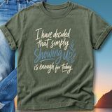 Olive green t-shirt with "I have decided that simply Showing up is enough for today" text.