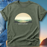 Olive green t-shirt featuring a sunset landscape with the word "DISTANCE."