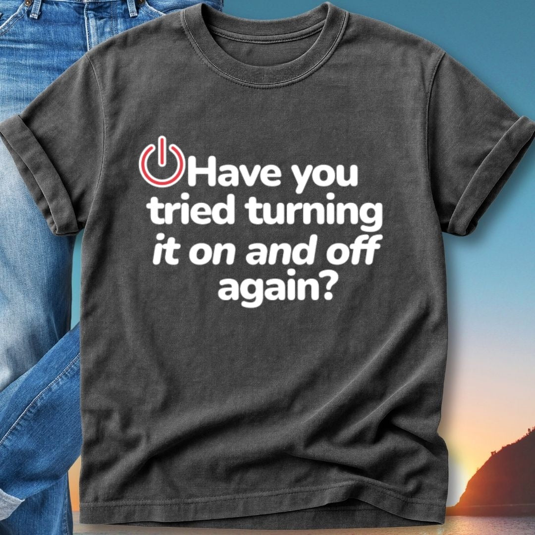 Black t-shirt with white text "Have you tried turning it on and off again?"