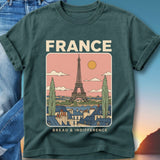 T-shirt graphic featuring Eiffel Tower over Parisian rooftops, with text "FRANCE" and "BREAD & INDIFFERENCE".