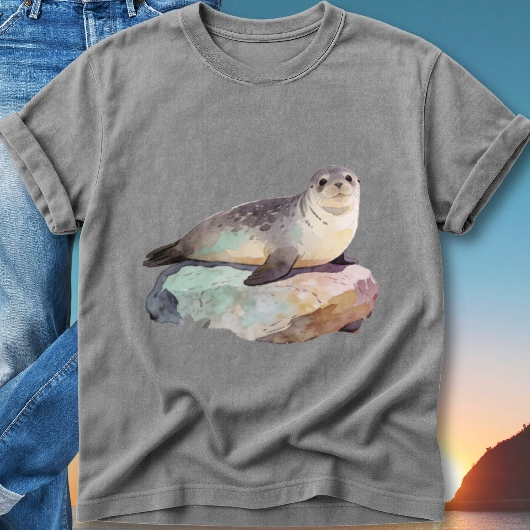 Gray t-shirt with watercolor painting of a seal resting on a rock.