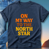 Navy t-shirt with orange and yellow text "ON MY WAY TO THE NORTH STAR".
