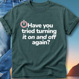 Dark t-shirt with "Have you tried turning it on and off again?"