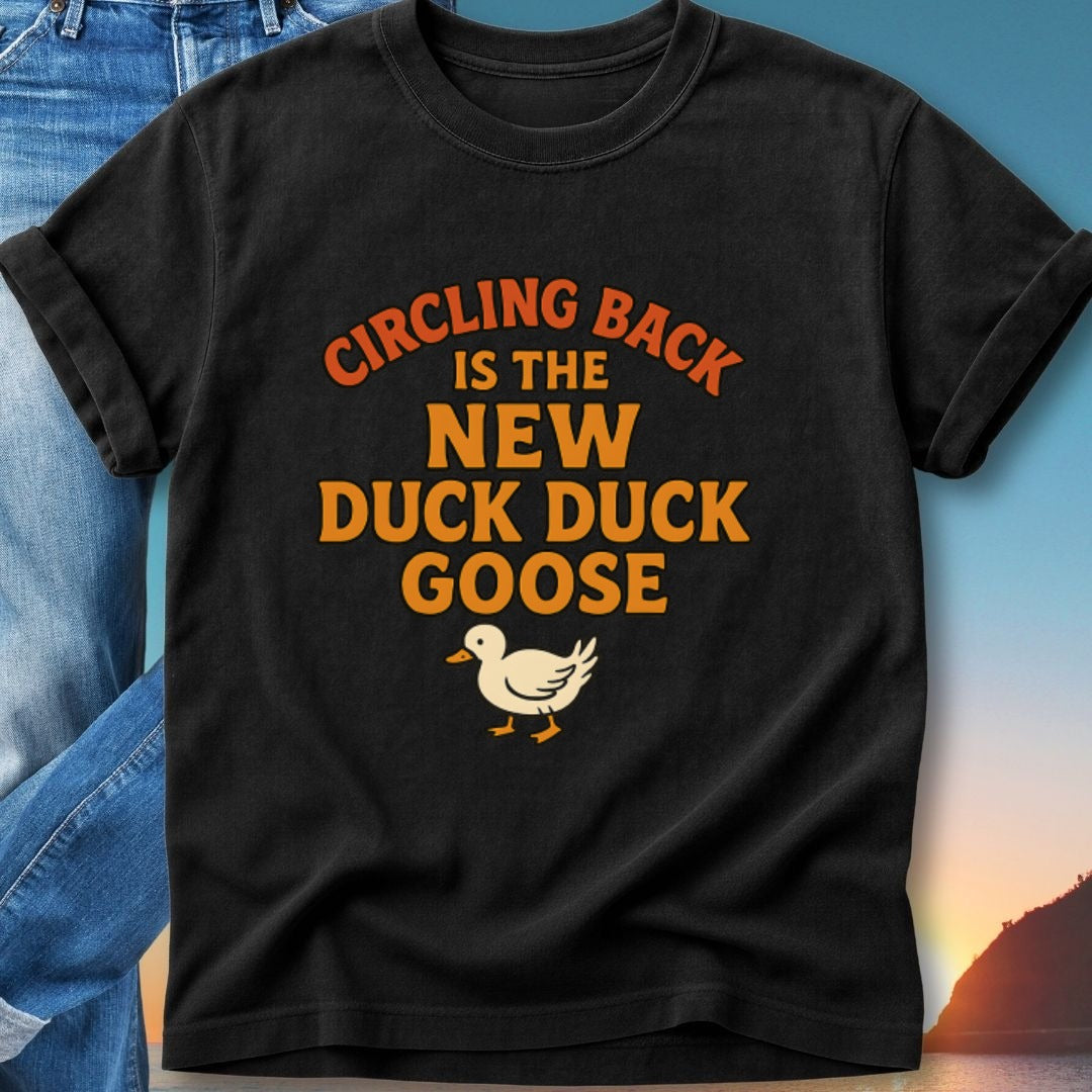 Black t-shirt with "Circling Back Is The New Duck Goose" and duck illustration.