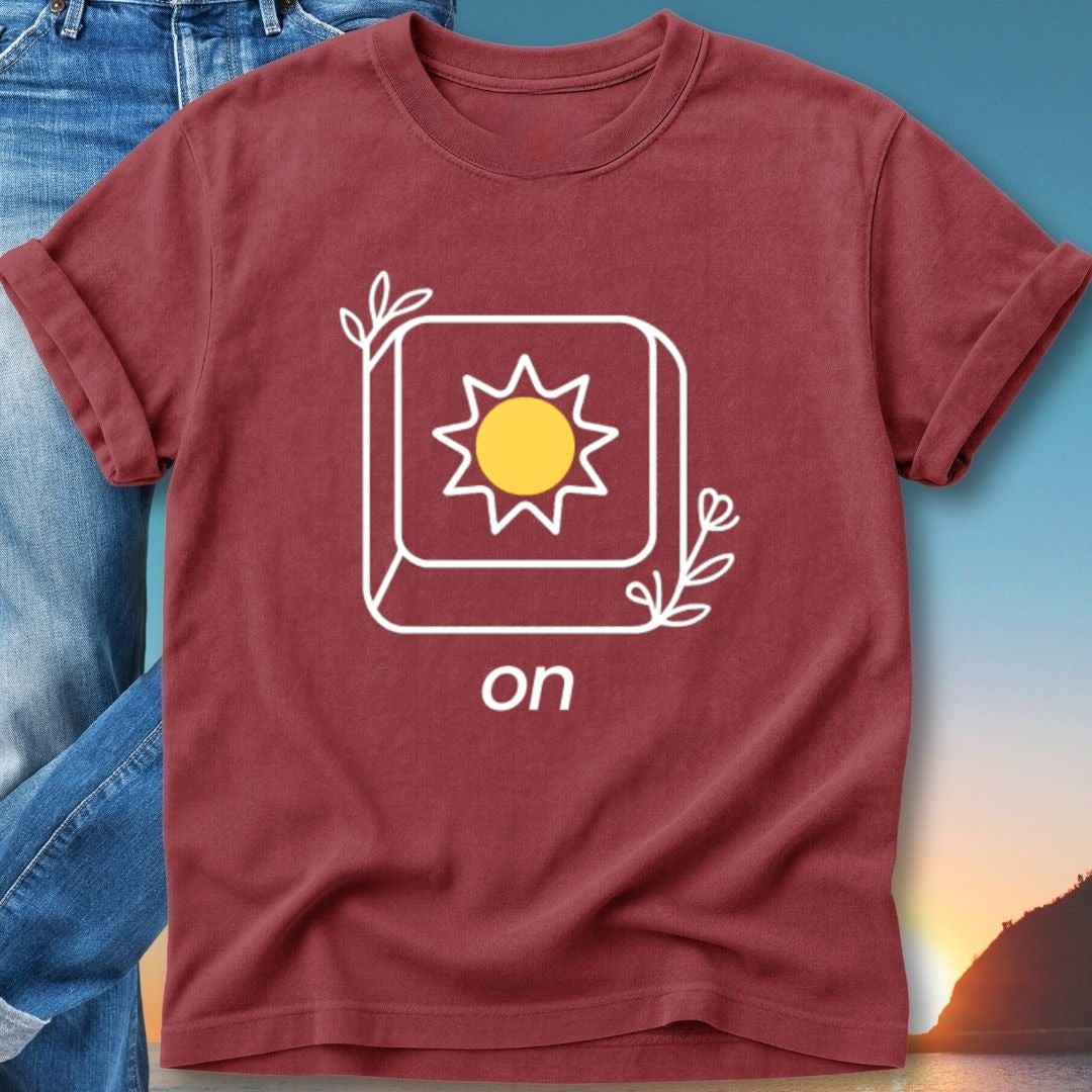 Maroon t-shirt with a sun icon and "on" text, set against a sunset background.