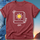 Maroon t-shirt with a sun icon and "on" text, set against a sunset background.
