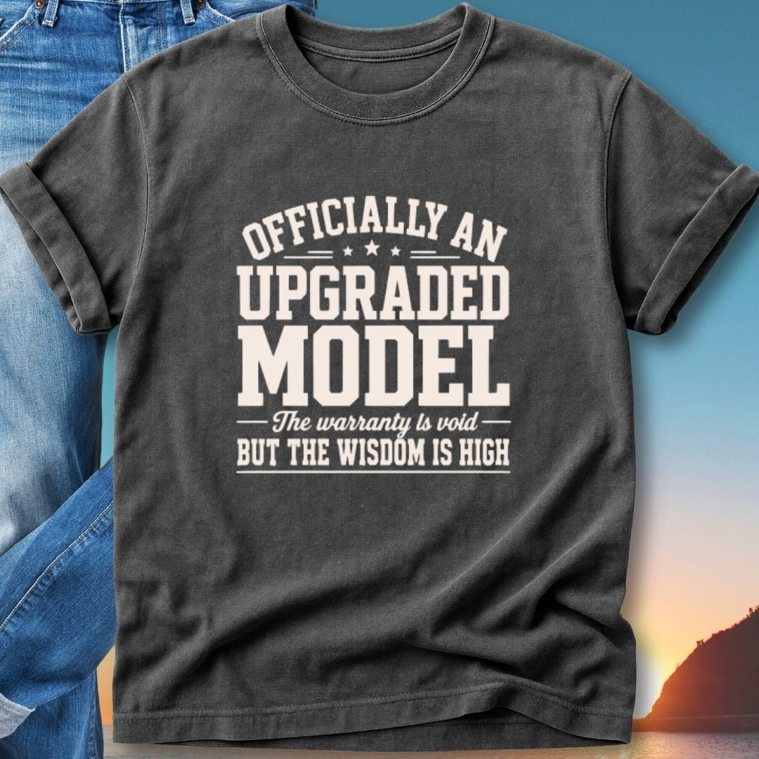 Dark t-shirt with "Officially An Upgraded Model, The warranty is void But the wisdom is high" text.
