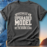 Dark t-shirt with "Officially An Upgraded Model, The warranty is void But the wisdom is high" text.