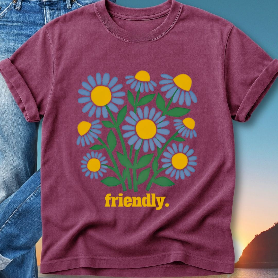 Maroon t-shirt with yellow and blue daisies and "friendly." text.