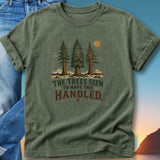 Green t-shirt with trees and mountains graphic, text reads "The trees seem to have this handled."