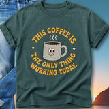 Teal t-shirt with a smiling coffee mug and text "This coffee is the only thing working today."