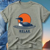 Loon swimming in water with orange sun and text "RELAX."