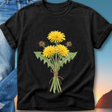 Black t-shirt with watercolor dandelions tied with twine on a gradient background.
