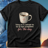 Black t-shirt with mug of coffee and text about a comfortable bed.