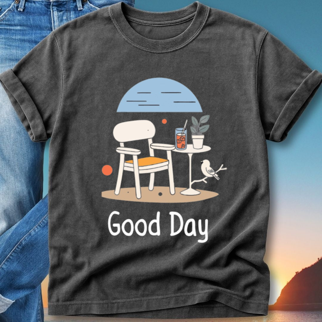 T-shirt featuring a graphic of a chair, table, drink, and bird with text "Good Day".