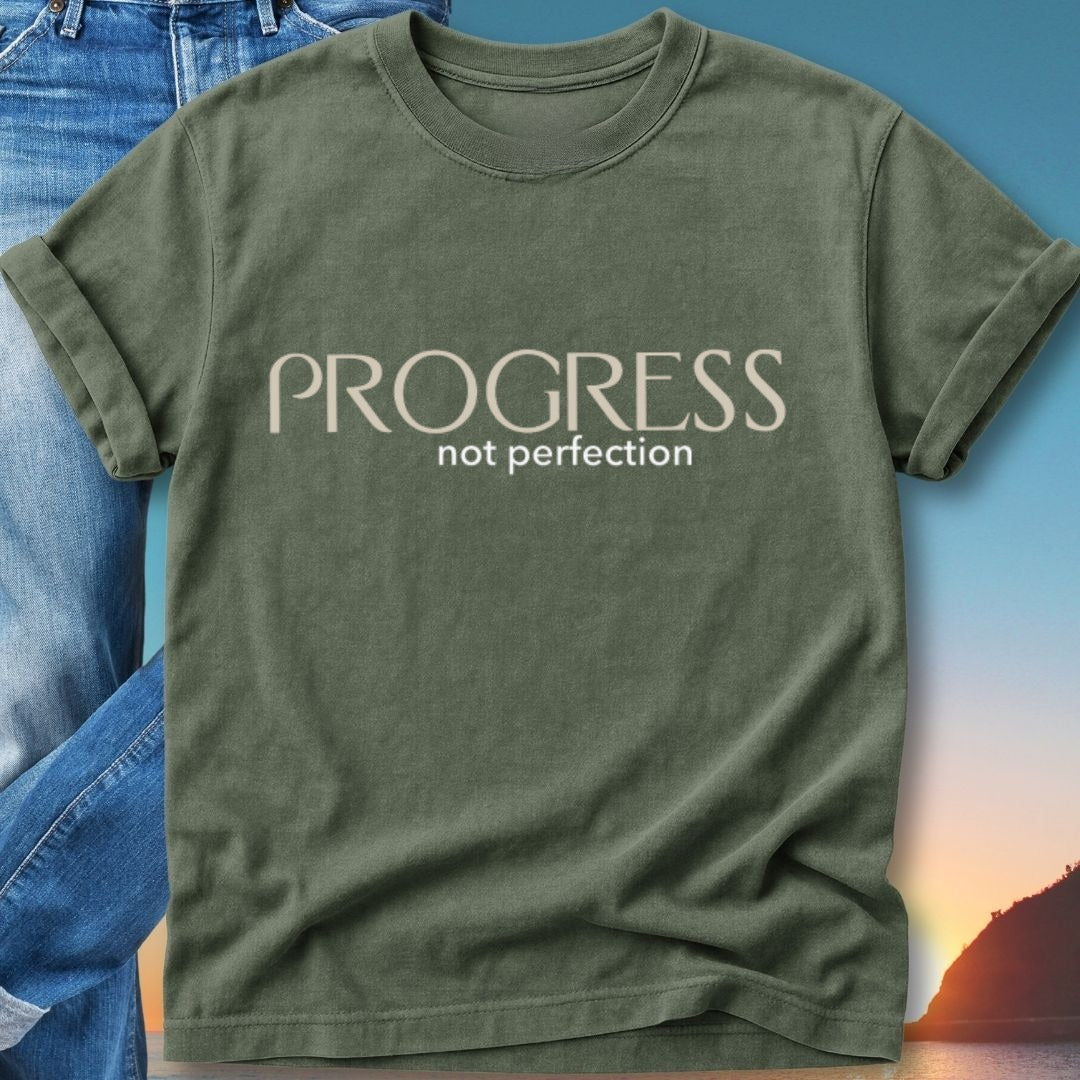Olive green t-shirt with "PROGRESS not perfection" text, displayed with jeans.