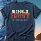 Navy t-shirt with "MY TO-DO LIST IS CURRENTLY GATHERING DUST." graphic.