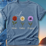 Blue t-shirt with "meet" and floral illustrations of rose, daisy, and poppy.