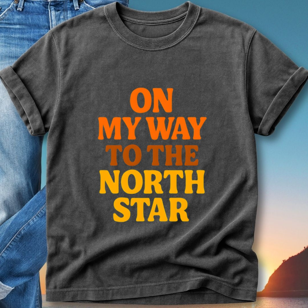 Black t-shirt with orange and yellow text "ON MY WAY TO THE NORTH STAR".