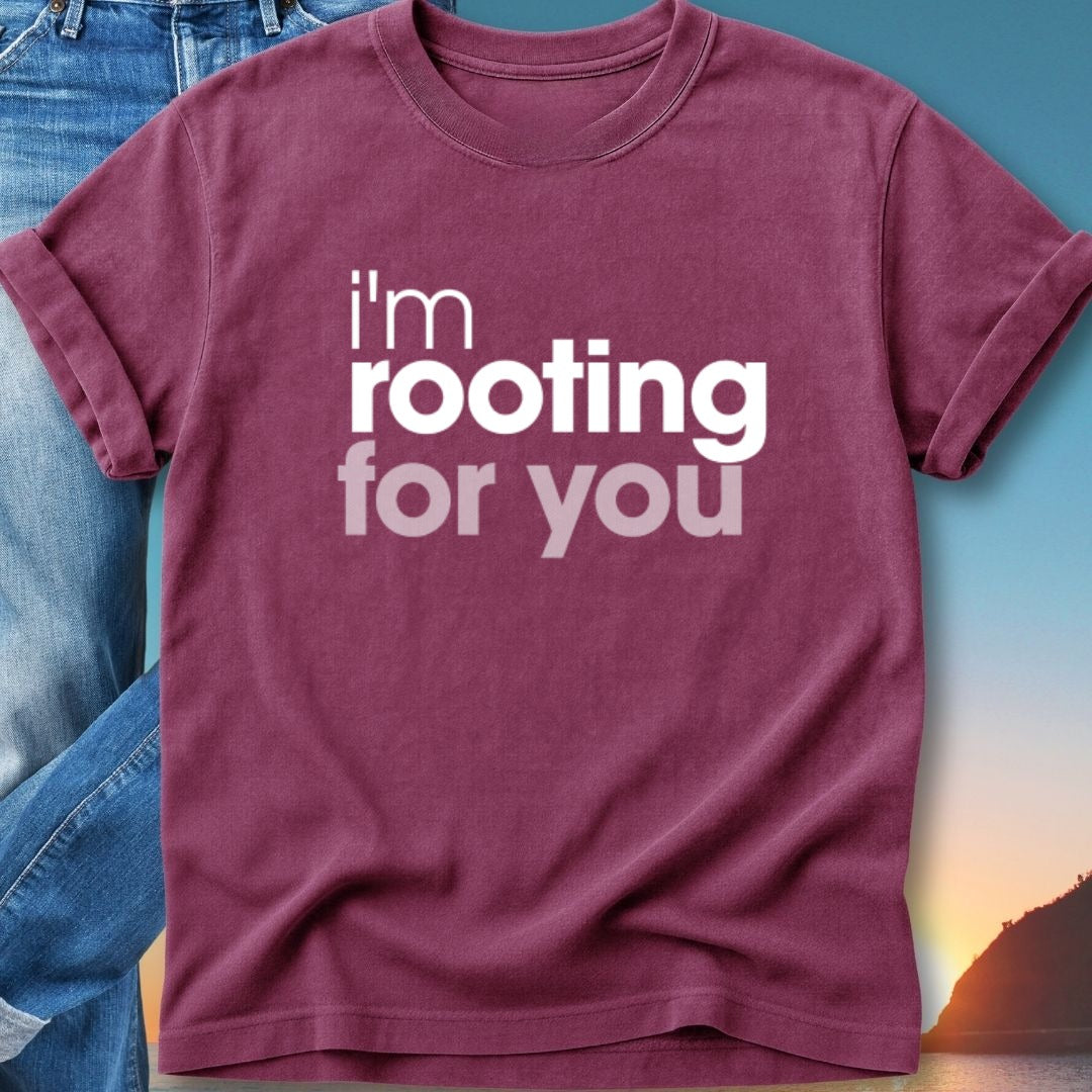 Maroon t-shirt with white text "I'm rooting for you" against a sunset backdrop.