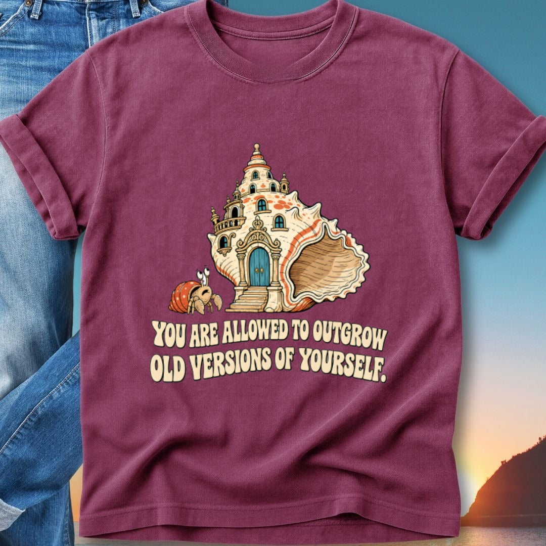 Burgundy t-shirt with shell house and crab, "You are allowed to outgrow old versions of yourself."