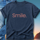 Navy t-shirt with "Smile." text in coral lettering.