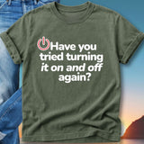 Green t-shirt with white text "Have you tried turning it on and off again?".