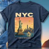 Navy t-shirt featuring Statue of Liberty, NYC skyline, sailboat, and text.