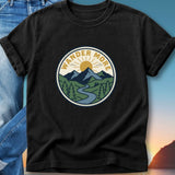 Black t-shirt with circular "Wander More" mountain landscape logo.