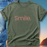 Olive green t-shirt with "Smile." text in pink lettering.
