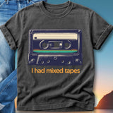 Dark t-shirt with a graphic of a vintage cassette tape and text "I had mixed tapes."