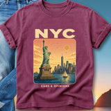 T-shirt with Statue of Liberty, NYC skyline, and sailboat in sunset.