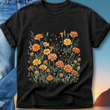 Black t-shirt with a watercolor floral design of orange and yellow flowers.