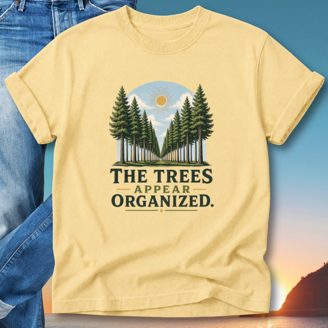 Yellow t-shirt with "The trees appear organized." text and a forest landscape graphic.